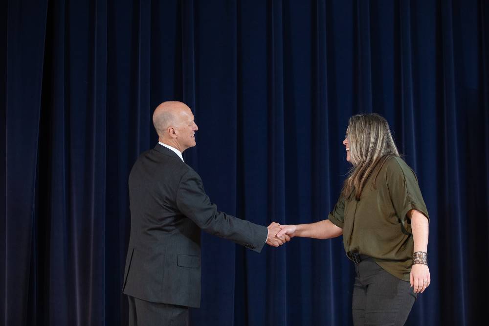 Amy Phillips shaking hands with Dr. Potteiger